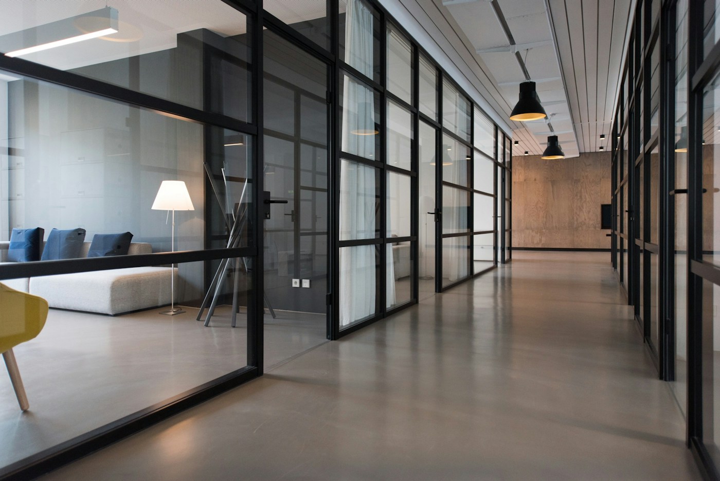 Light-filled creative workspace with shared tables and greenery